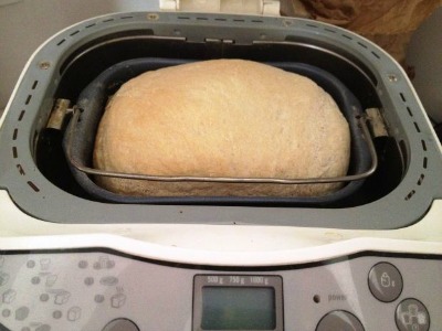 bread machine with loaf of bread in it