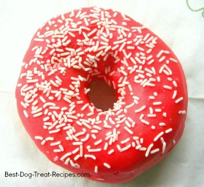 red donut for dog with white sprinkles