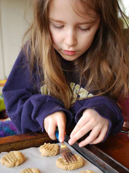 young girl making homemade dog cookies